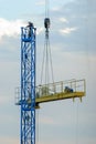 disassembly of construction cranes using a lifting arm with the assistance of workers Royalty Free Stock Photo