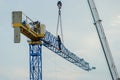 disassembly of construction cranes using a lifting arm and the assistance of workers Royalty Free Stock Photo