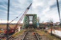 Disassembly and cutting of the old steel railway bridge and rusty rails