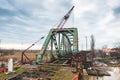 Disassembly and cutting of the old steel railway bridge and rusty rails