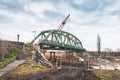 Disassembly and cutting of the old steel railway bridge and rusty rails