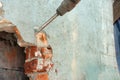 Disassembly of walls and openings with an electric jackhammer, close-up, dust hoarse from under the chisel