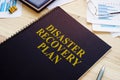 Disaster recovery plan book and stack of papers Royalty Free Stock Photo