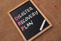 Disaster Recovery Plan, text words typography written on chalkboard against wooden background, life and business motivational