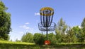 Disc golf basket and frisbee Royalty Free Stock Photo