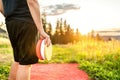 Disc golf in summer at sunset. Man with frisbee equipment in park course. Guy playing discgolf. Player in outdoor sport tournament Royalty Free Stock Photo