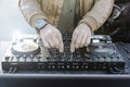 Disc jockey hands playing music for tourist people at beach party outdoor - Live event, music and fun concept - Entertainment and Royalty Free Stock Photo