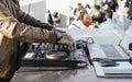 Disc jockey hands playing music for tourist people at beach party outdoor - Live event, music and fun concept - Entertainment and Royalty Free Stock Photo