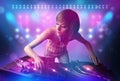 Disc jockey mixing music on turntables on stage with lights and Royalty Free Stock Photo