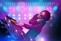 Disc jockey mixing music on turntables on stage with lights and Royalty Free Stock Photo