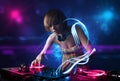 Disc jockey playing music with electro light effects and lights