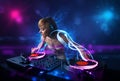 Disc jockey playing music with electro light effects and lights Royalty Free Stock Photo