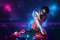 Disc jockey playing music with electro light effects and lights Royalty Free Stock Photo