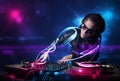 Disc jockey playing music with electro light effects and lights Royalty Free Stock Photo