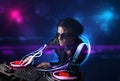 Disc jockey playing music with electro light effects and lights Royalty Free Stock Photo