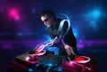 Disc jockey playing music with electro light effects and lights Royalty Free Stock Photo
