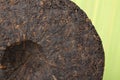 Disc of puer tea on green background Royalty Free Stock Photo