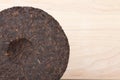 Disc of puer tea on wooden background Royalty Free Stock Photo
