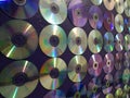 wall decorated with CDs and DVDs, textured background Royalty Free Stock Photo