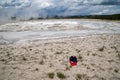 Discarded baseball hat littered and thrown in the fountain paint pots geysers and geothermal features of the lower geyser basin in Royalty Free Stock Photo