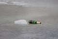 Discarded bottle of champagne on ice Royalty Free Stock Photo