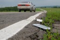 A discarded broken phone is lying on the road