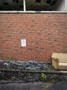 Abandoned Couch and Red Brick Wall Exterior of Abandoned Building Background. Royalty Free Stock Photo