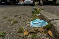 Discarded Covid face mask laying on the street Royalty Free Stock Photo