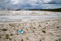 Discarded face mask covering thrown in the fountain paint pots geysers and geothermal features of the lower geyser basin in