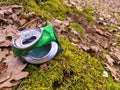 Discarded green aluminium beer or soda can in a forest Royalty Free Stock Photo