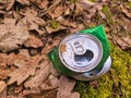 Discarded green aluminium beer or soda can in a forest Royalty Free Stock Photo