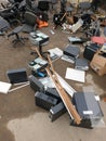 discarded obsolete system units from computers with old office chairs in trash