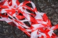 Red and white barrier tape in a pile on the ground