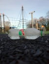 Discarded plastic bottle of Spring Water in a Play Area