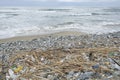 Discarded plastic debris trash pollution after sea swell storm,environmental nature waste