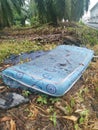 Discarded queen size mattress thrown in the farm