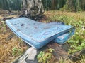 Discarded queen size mattress thrown in the farm