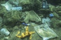 Discarded used medical face mask along with other plastic debris lies on the seabed. Becici, Budva Municipality, Montenegro