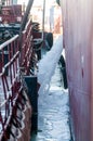 Discharge of ballast water on the deck of an oil tanker in the bay in the port