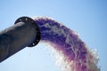 Discharge of brown liquid from a pipe on a blue sky background. The concept of pollution of nature by industrial wastewater