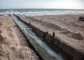 Discharge of dirty industrial wastewater into sea. Poisoning of recreation area by spread of disease, destruction of flora and Royalty Free Stock Photo