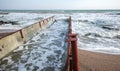 Discharge of dirty industrial wastewater into sea. Poisoning of recreation area by spread of disease, destruction of flora and Royalty Free Stock Photo