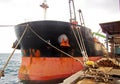 Discharging of cargo scrap metal from cargo ship in the port of Iskenderun, Turkey. A close-up view of cargo residues on the deck