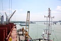 Discharging the vessel in the port of Saigon, Vietnam, the Mekong River. Views of berths, river banks and ships,tugs.