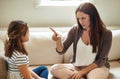 Discipline starts here. a young girl being reprimanded by her mother at home.