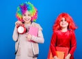 Discipline and time concept. Circus school education. Time to have fun. Kids colorful curly wig clown style hold alarm