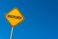 disciplined - yellow sign with blue sky