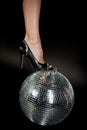 Disco ball , it female foot in shoes .A symbol of music, clubs and nightlife. Holidays and fun parties