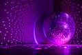 Disco ball reflecting purple light in a dark hall. Disco symbol. Royalty Free Stock Photo