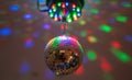 Disco ball system with reflecting lights in dark party nightclub interior
